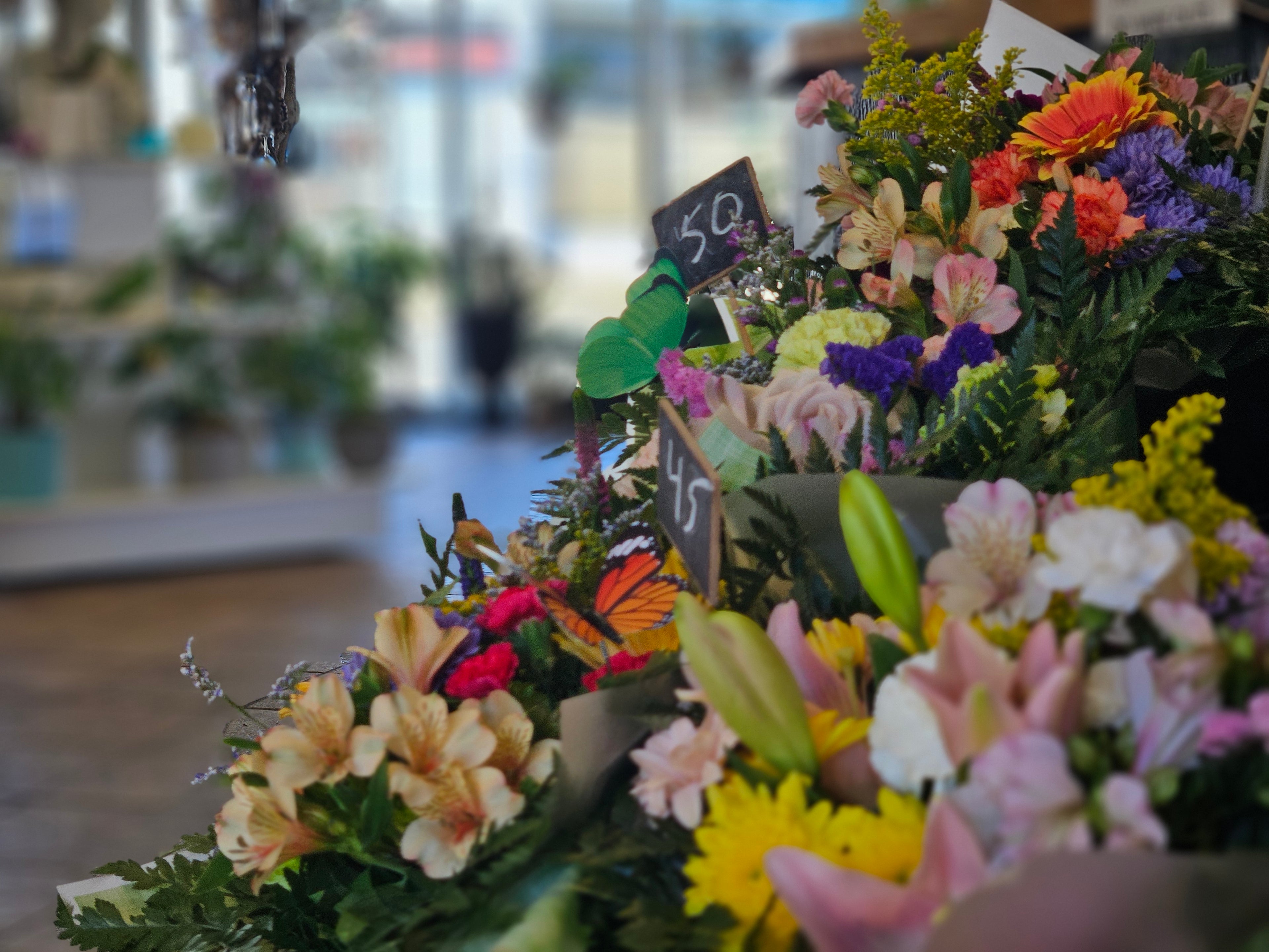 Bouquets of flowers on display with blurred indoor background