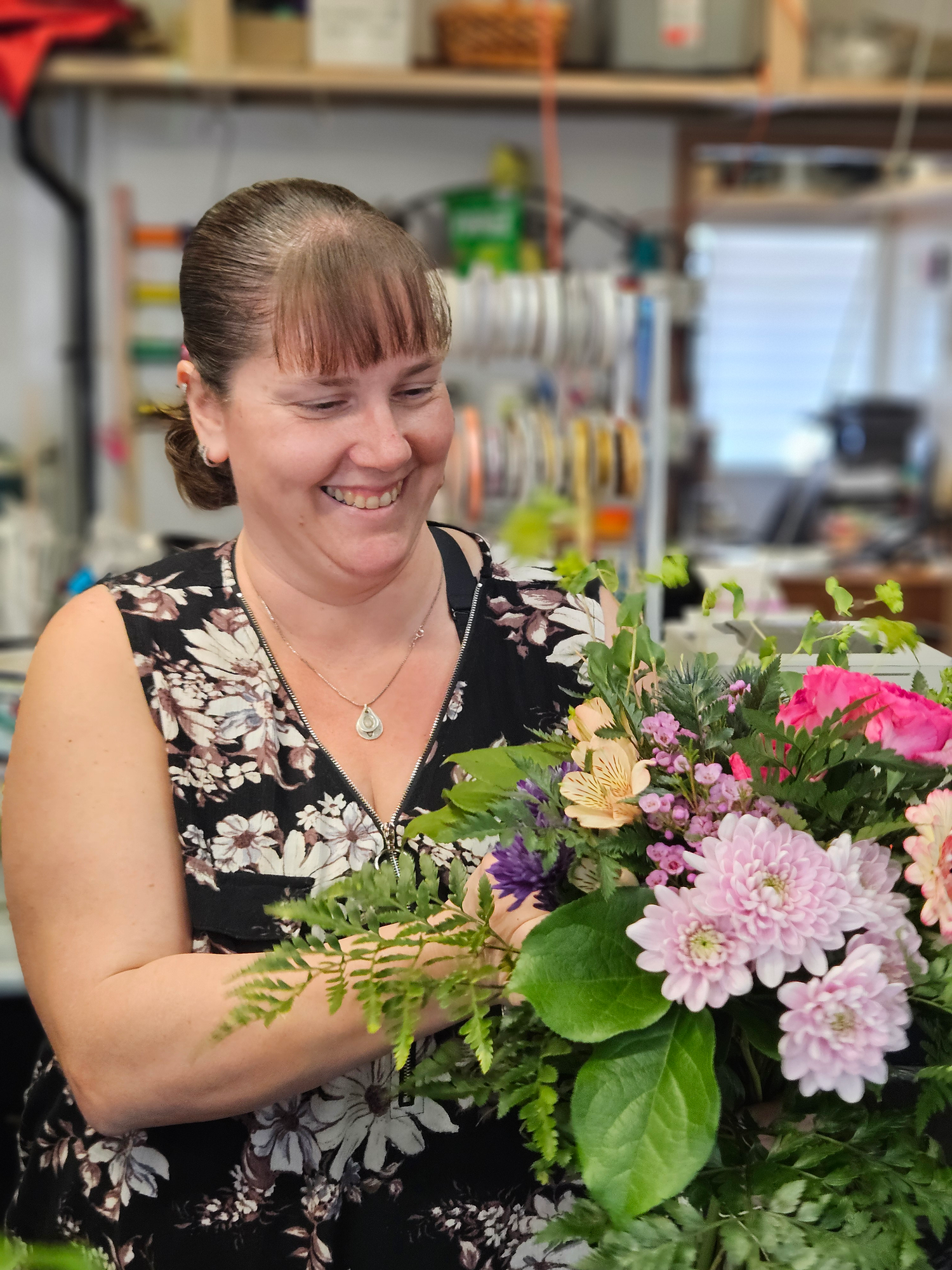 Happy Woman Learning Flower Arrangement during Turleys Florist Floral Workshop
