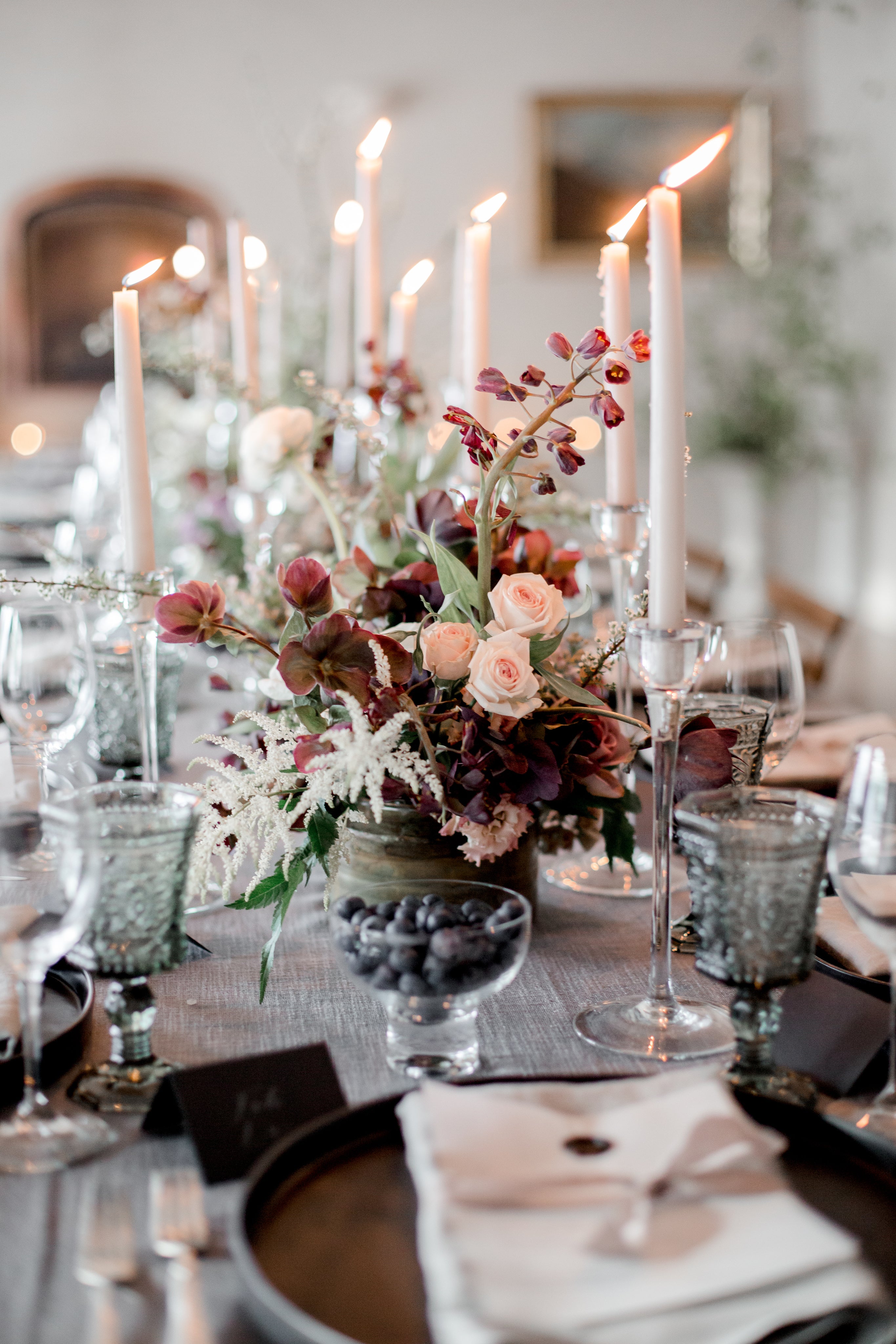 A table arrangement of flowers and candles 